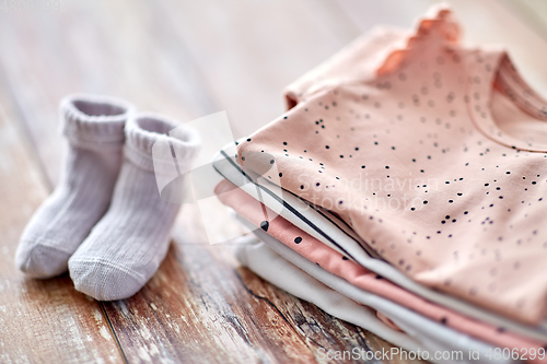 Image of close up of baby clothes on wooden table