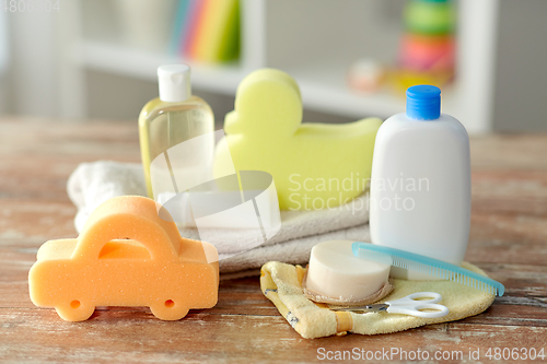 Image of baby accessories for bathing on wooden table