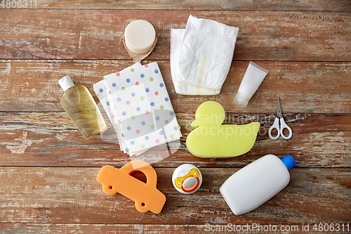 Image of baby accessories for bathing on wooden table