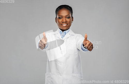 Image of african american female doctor showing thumbs up