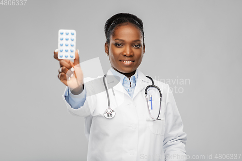 Image of african american female doctor with medicine pills