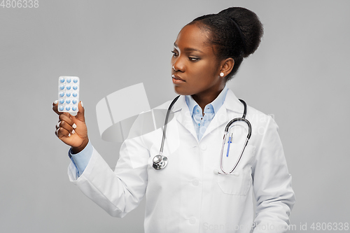 Image of african american female doctor with medicine pills