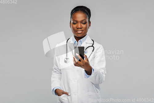 Image of african american female doctor with smartphone