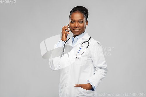 Image of african female doctor calling on smartphone