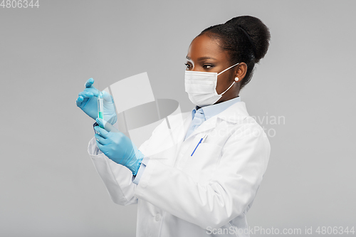 Image of african american female doctor with syringe