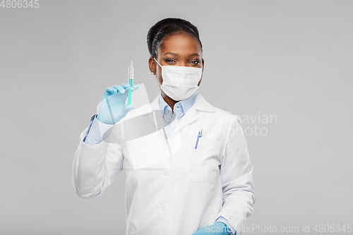 Image of african american female doctor with syringe