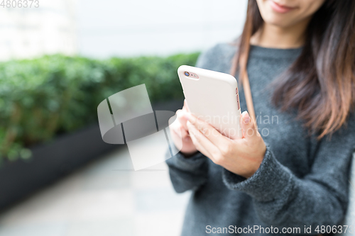 Image of Woman use of mobile phone at outdoor