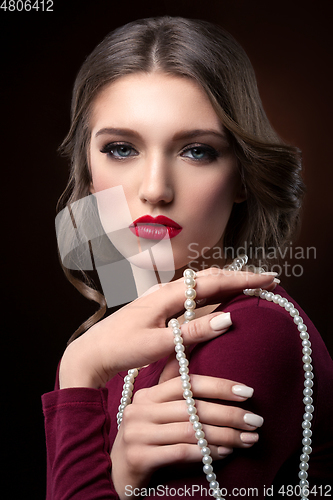 Image of beautiful girl with pearl necklace
