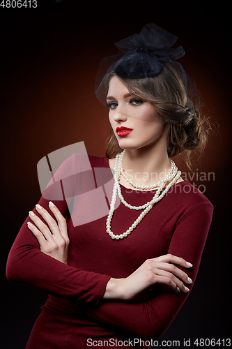 Image of beautiful girl with pearl necklace and veil hat