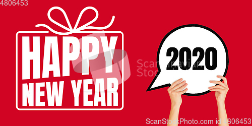 Image of Female hands holding comment sign with wishes of happy New Year and Merry Christmas