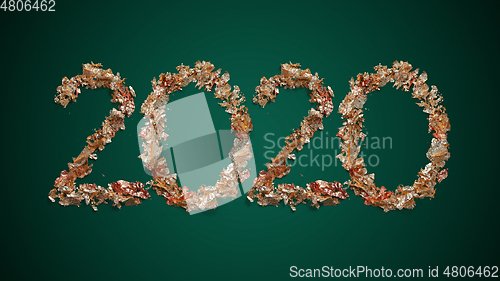 Image of New Year wishes and 2020 made of golden leaves on green backgrou