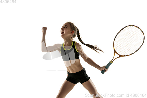 Image of Little caucasian girl playing tennis isolated on white background