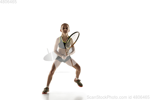 Image of Little caucasian girl playing tennis isolated on white background