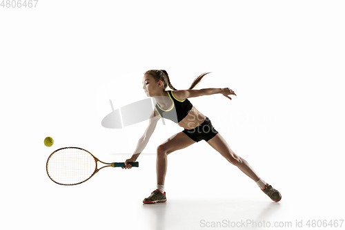 Image of Little caucasian girl playing tennis isolated on white background