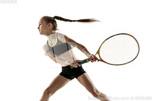 Image of Little caucasian girl playing tennis isolated on white background