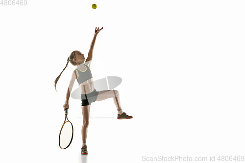 Image of Little caucasian girl playing tennis isolated on white background