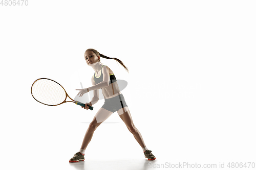 Image of Little caucasian girl playing tennis isolated on white background