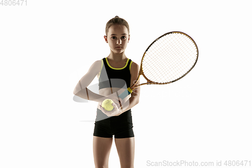 Image of Little caucasian girl playing tennis isolated on white background