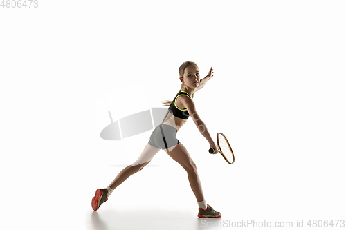 Image of Little caucasian girl playing tennis isolated on white background