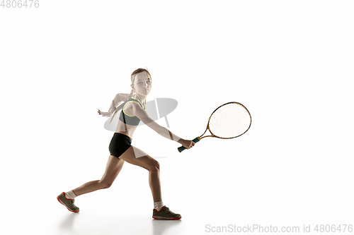 Image of Little caucasian girl playing tennis isolated on white background