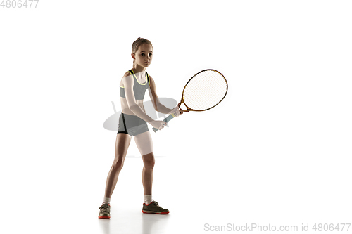 Image of Little caucasian girl playing tennis isolated on white background
