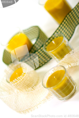 Image of five yellow candles and ribbon