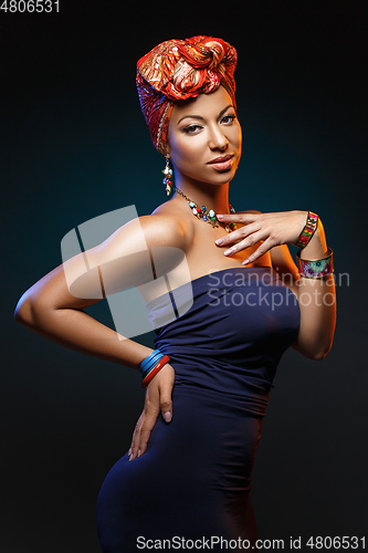 Image of beautiful mulatto young woman with turban on head