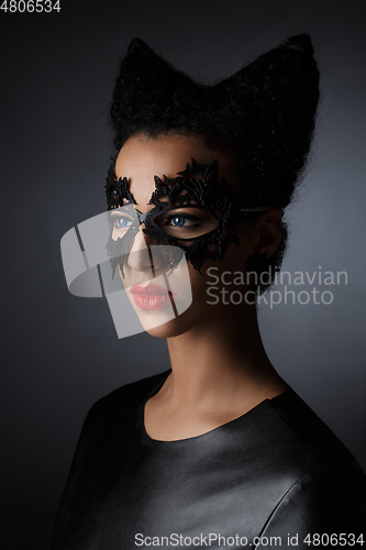 Image of girl with horns hairstyle in leather mask