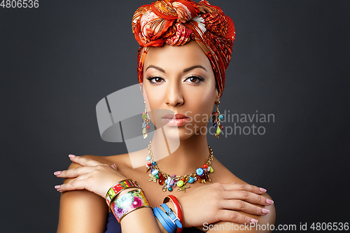 Image of beautiful mulatto young woman with turban on head