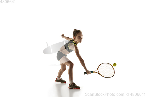 Image of Little caucasian girl playing tennis isolated on white background