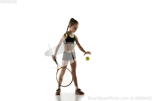 Image of Little caucasian girl playing tennis isolated on white background