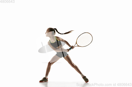 Image of Little caucasian girl playing tennis isolated on white background