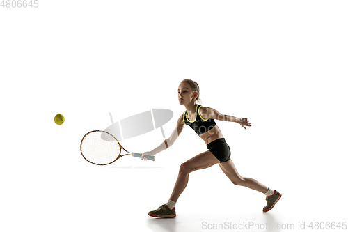 Image of Little caucasian girl playing tennis isolated on white background