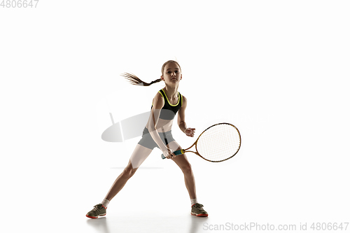 Image of Little caucasian girl playing tennis isolated on white background