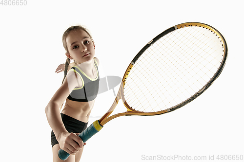 Image of Little caucasian girl playing tennis isolated on white background