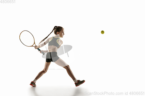 Image of Little caucasian girl playing tennis isolated on white background