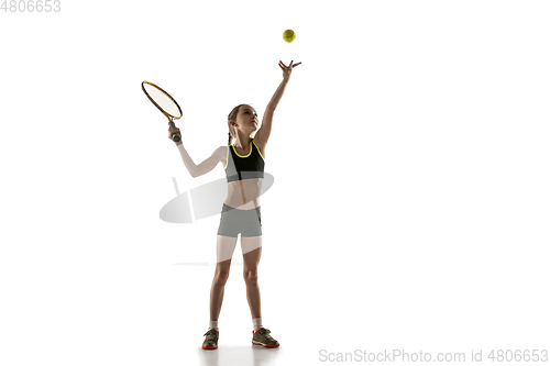 Image of Little caucasian girl playing tennis isolated on white background