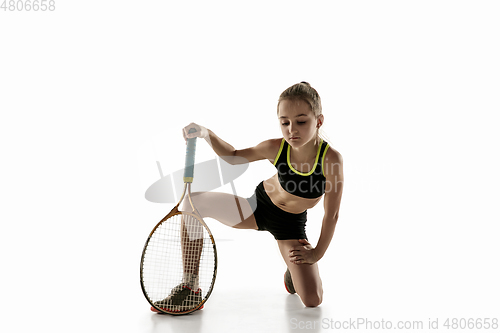 Image of Little caucasian girl playing tennis isolated on white background
