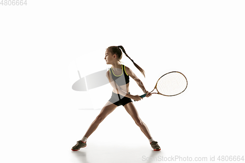 Image of Little caucasian girl playing tennis isolated on white background