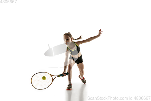 Image of Little caucasian girl playing tennis isolated on white background