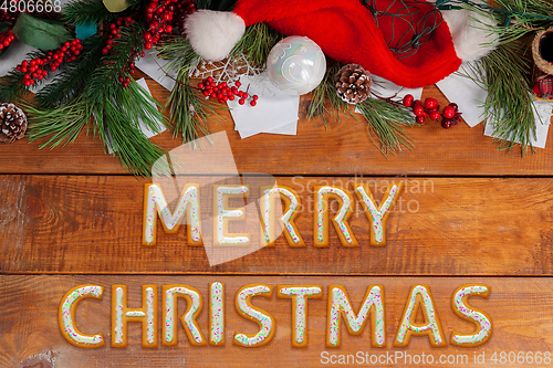 Image of New Year wishes made of cakes on wooden table background