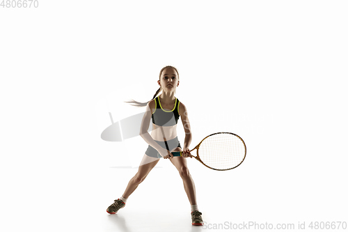 Image of Little caucasian girl playing tennis isolated on white background