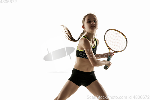 Image of Little caucasian girl playing tennis isolated on white background