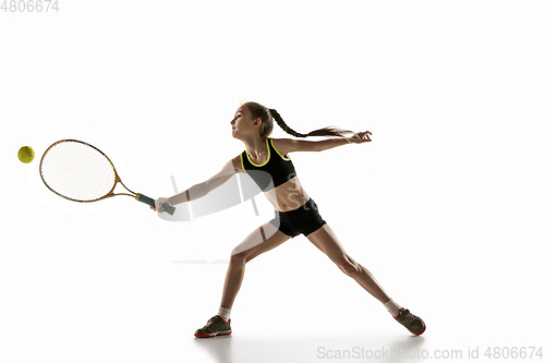 Image of Little caucasian girl playing tennis isolated on white background