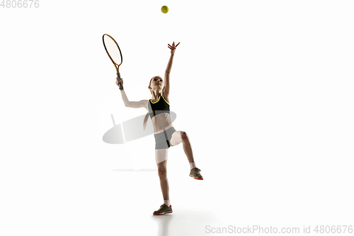 Image of Little caucasian girl playing tennis isolated on white background