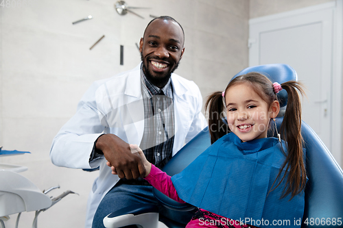 Image of Young caucasian girl visiting dentist\'s office, smiling