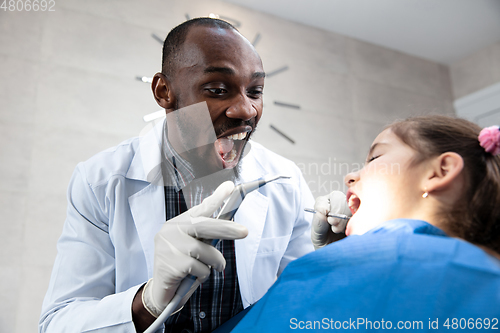 Image of Young caucasian girl visiting dentist\'s office