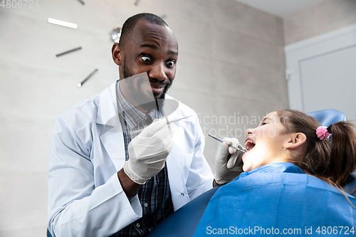 Image of Young caucasian girl visiting dentist\'s office, smiling
