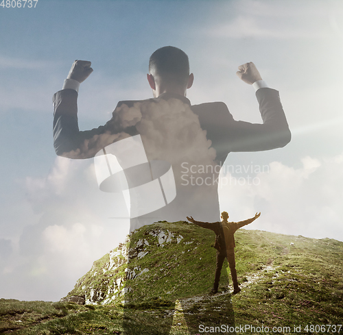 Image of Silhouette of businessman with landscapes on background, double exposure.