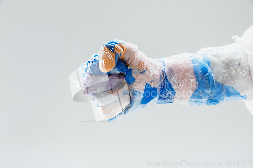 Image of Big plastic hand made of garbage isolated on white studio background